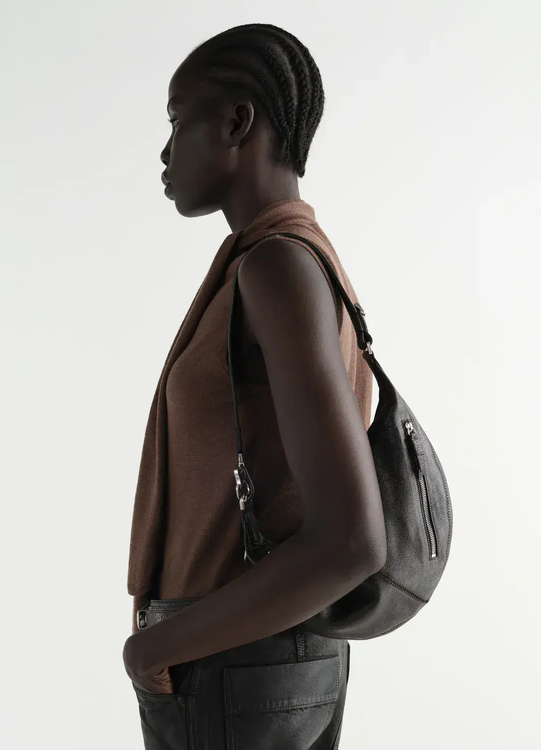 A model carrying a large black leather shoulder bag